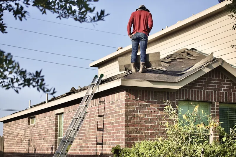 Professional roofer working on a residential roof in Stocksville